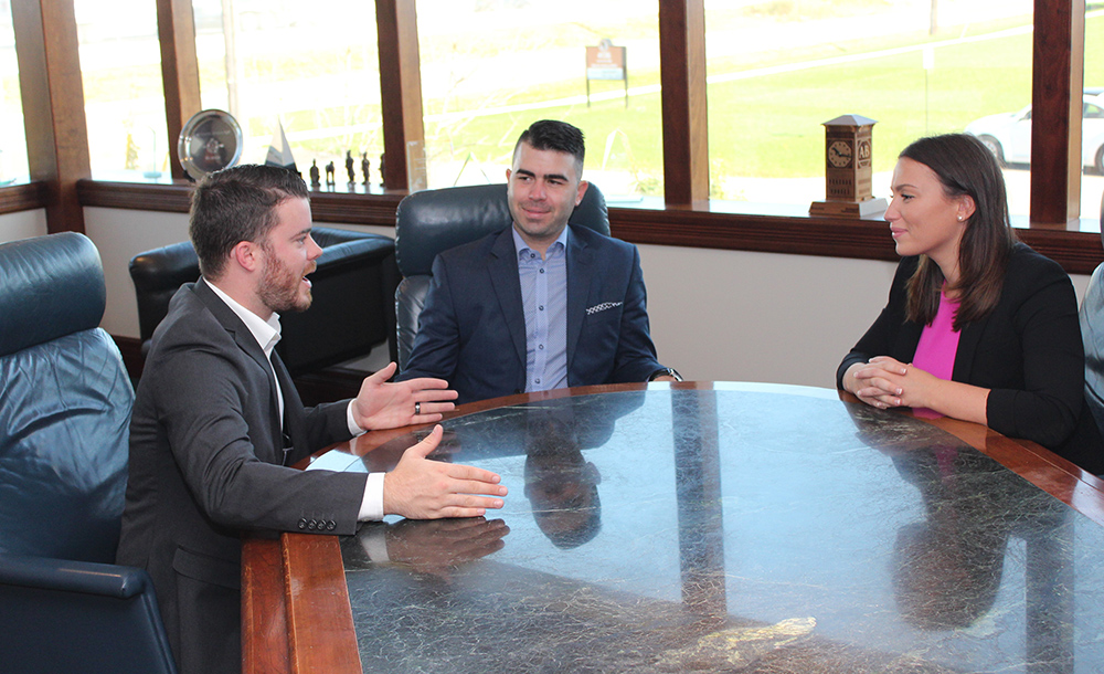 Employees at office table discussing